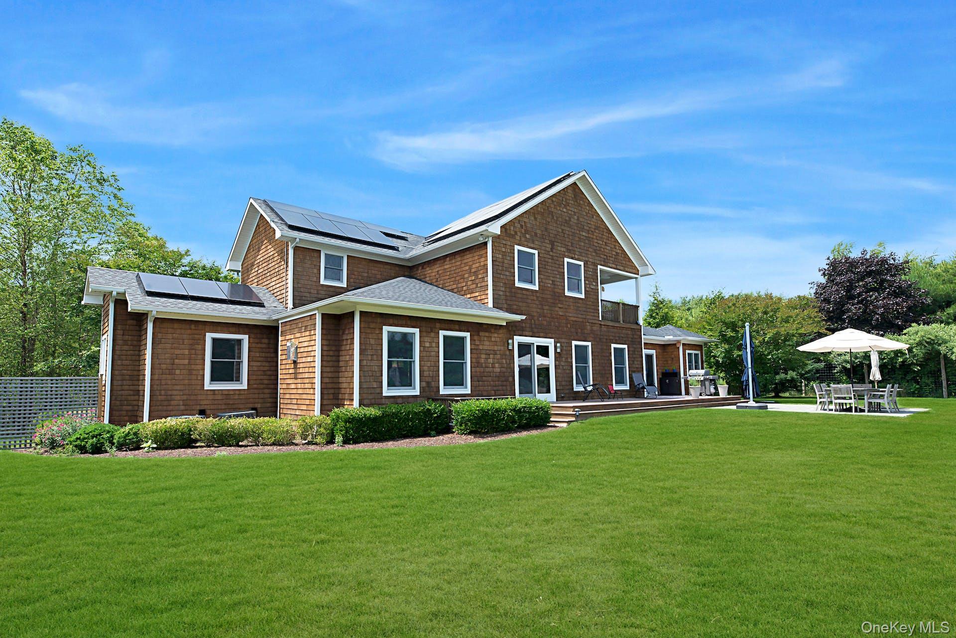 450 Sterling Woods Lane Southold, NY 11971 - Photo 32 of 41 a front view of a house with a yard
