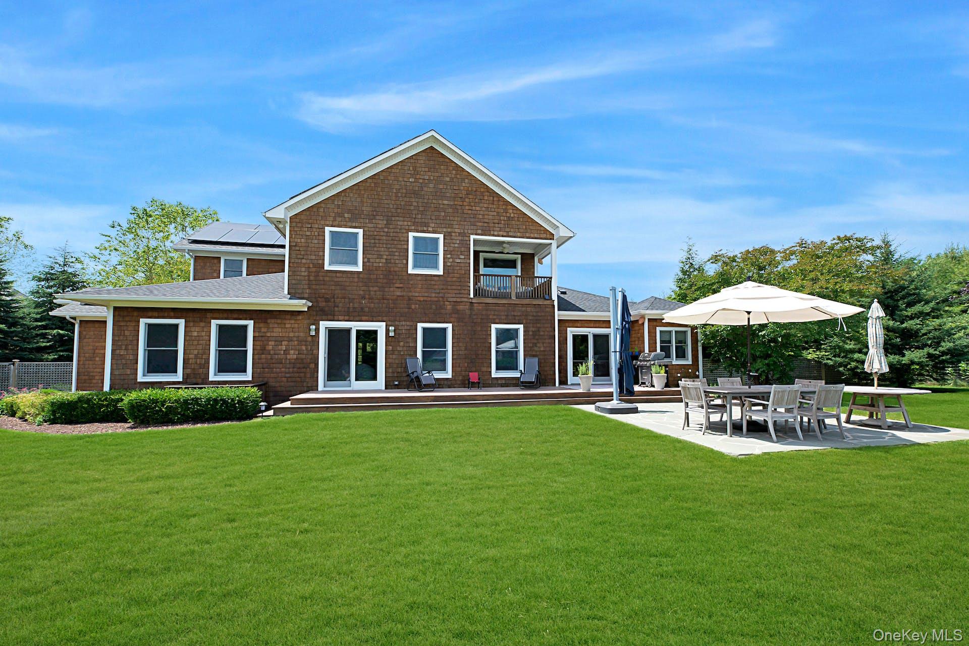 450 Sterling Woods Lane Southold, NY 11971 - Photo 33 of 41 a front view of a house with a yard