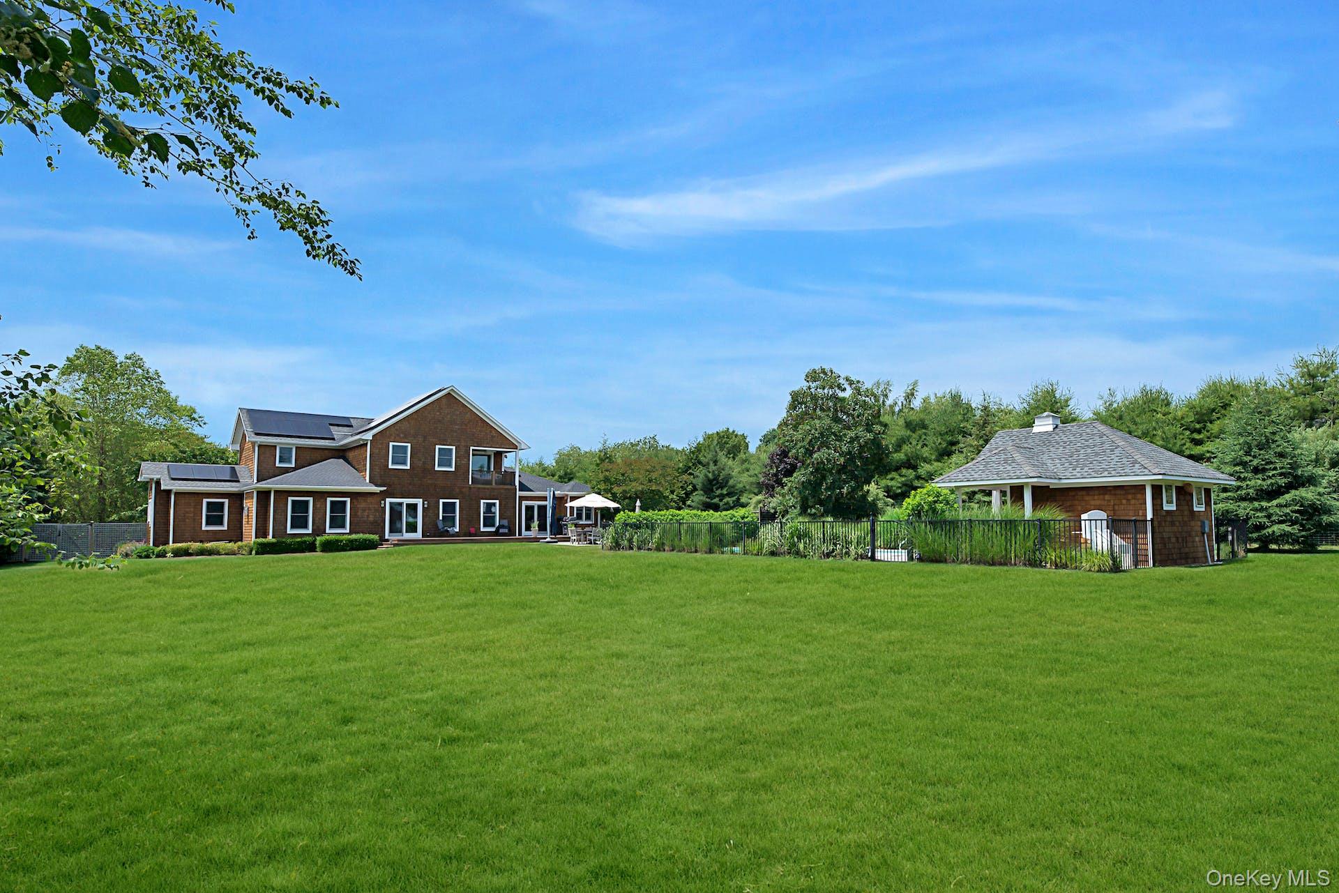 450 Sterling Woods Lane Southold, NY 11971 - Photo 36 of 41 a view of a house with a big yard