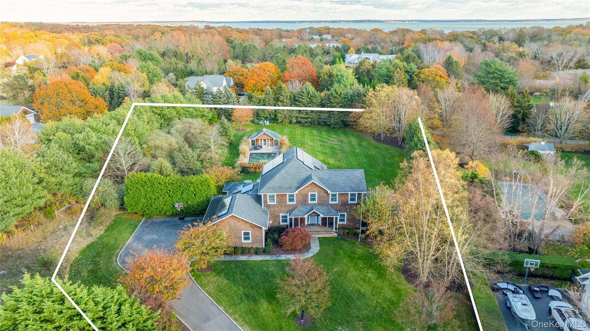 450 Sterling Woods Lane Southold, NY 11971 - Photo 37 of 41 an aerial view of a house with a yard and lake view