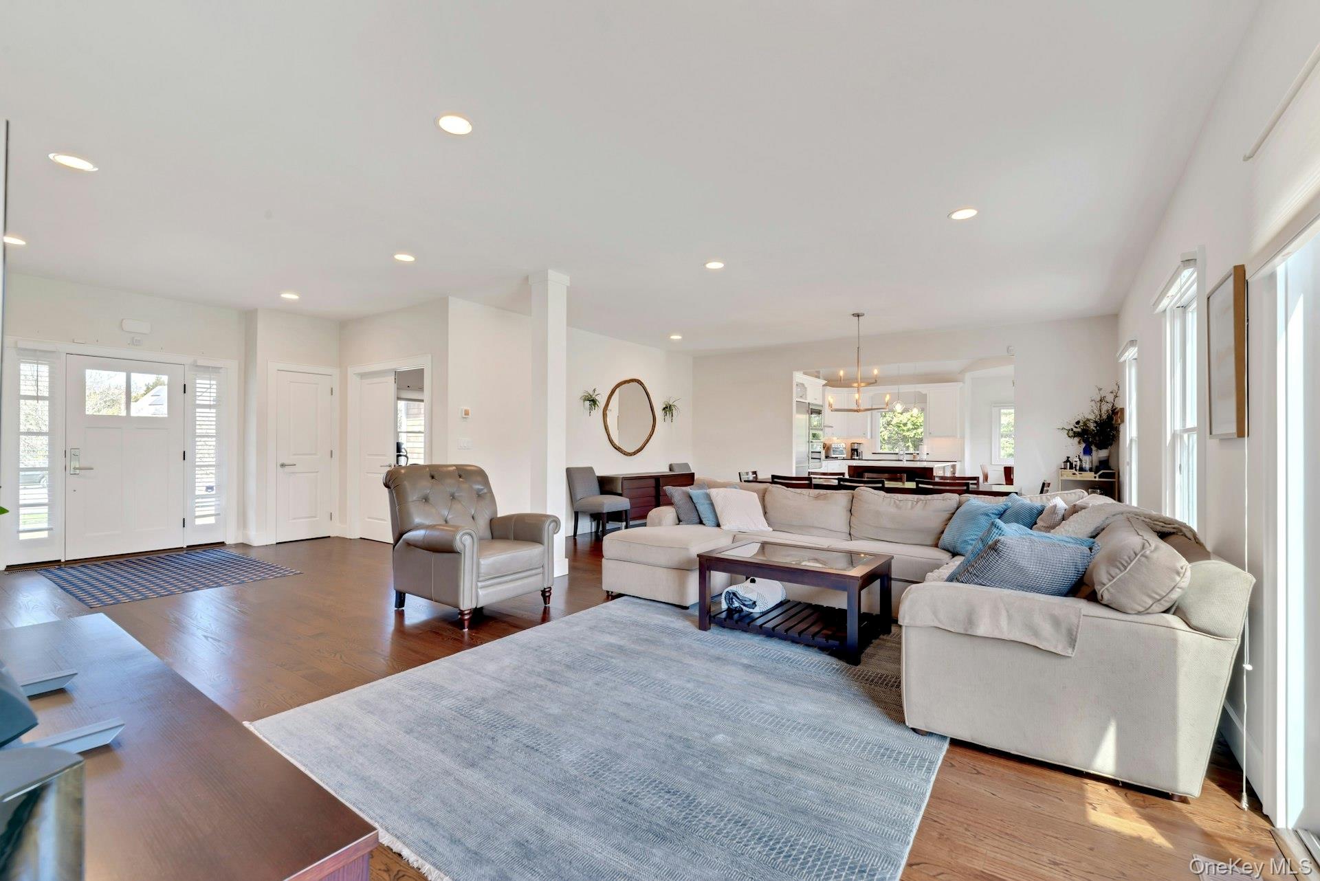 450 Sterling Woods Lane Southold, NY 11971 - Photo 5 of 41 a living room with lots of furniture and kitchen view