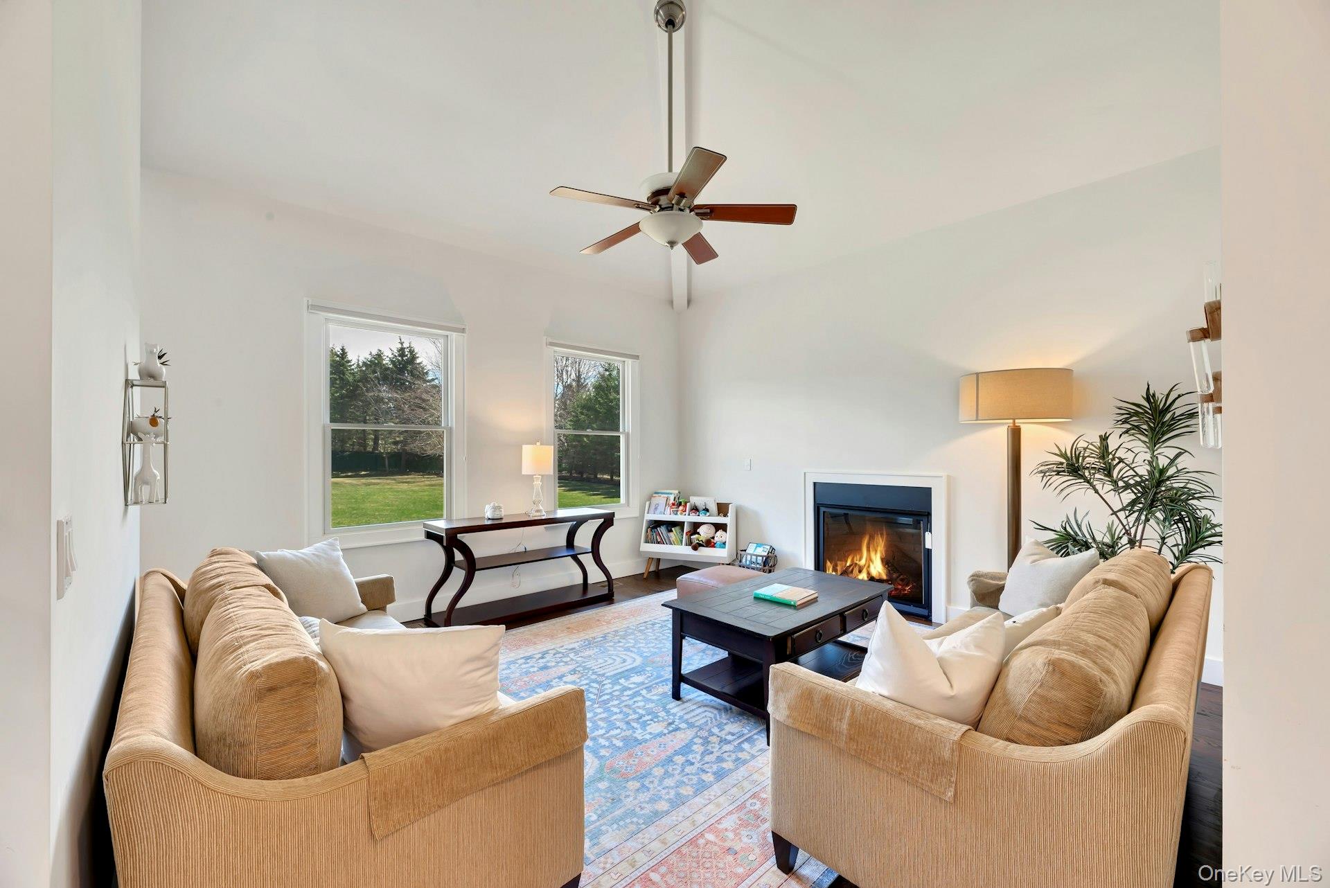 450 Sterling Woods Lane Southold, NY 11971 - Photo 6 of 41 a living room with furniture and a fireplace