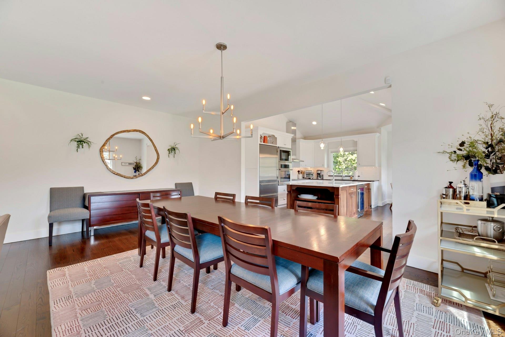 450 Sterling Woods Lane Southold, NY 11971 - Photo 8 of 41 a dining room filled chandelier and wooden floor