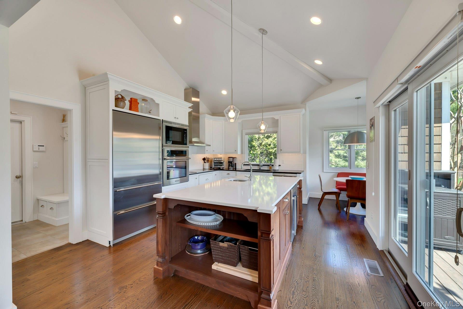 450 Sterling Woods Lane Southold, NY 11971 - Photo 9 of 41 a view of a kitchen with kitchen island a counter top space appliances and a ceiling fan