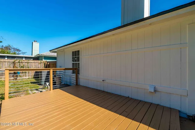 a view of a balcony with wooden floor