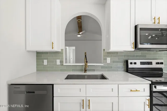 a kitchen with a sink and cabinets