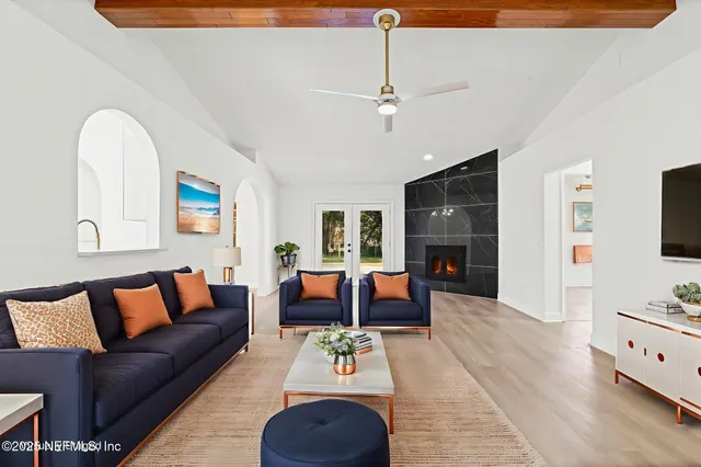 a living room with furniture fireplace and flat screen tv