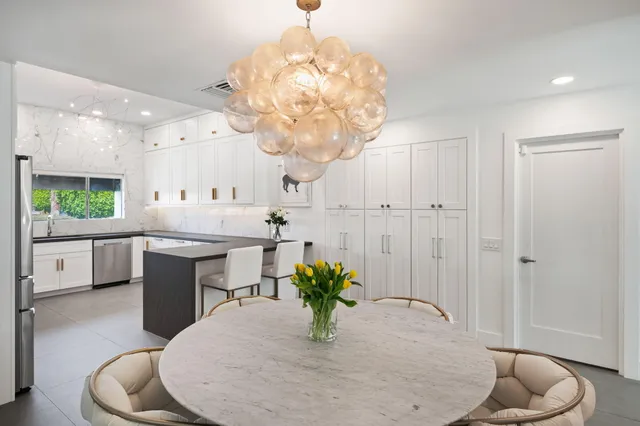a kitchen with a sink and chandelier