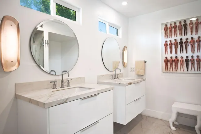 a bathroom with a double vanity sink and a mirror