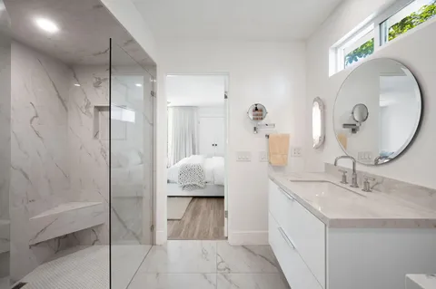 a en suite bathroom with a double vanity sink and a mirror