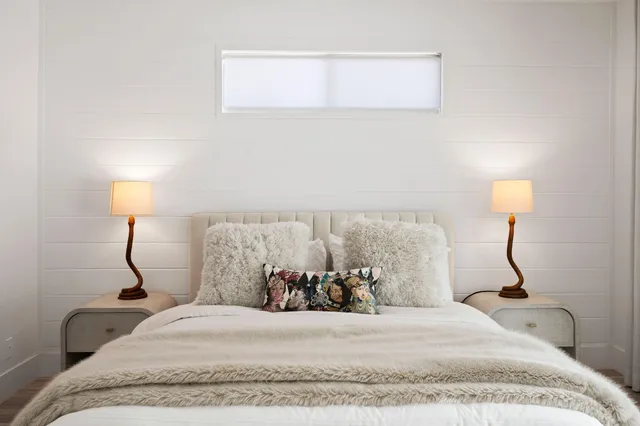 a bedroom with a bed and a lamp