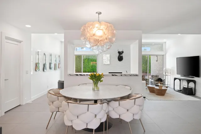 a view of a dining room with furniture and a chandelier