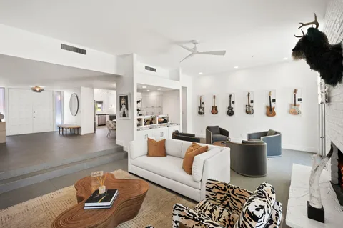 a living room with furniture and view of kitchen