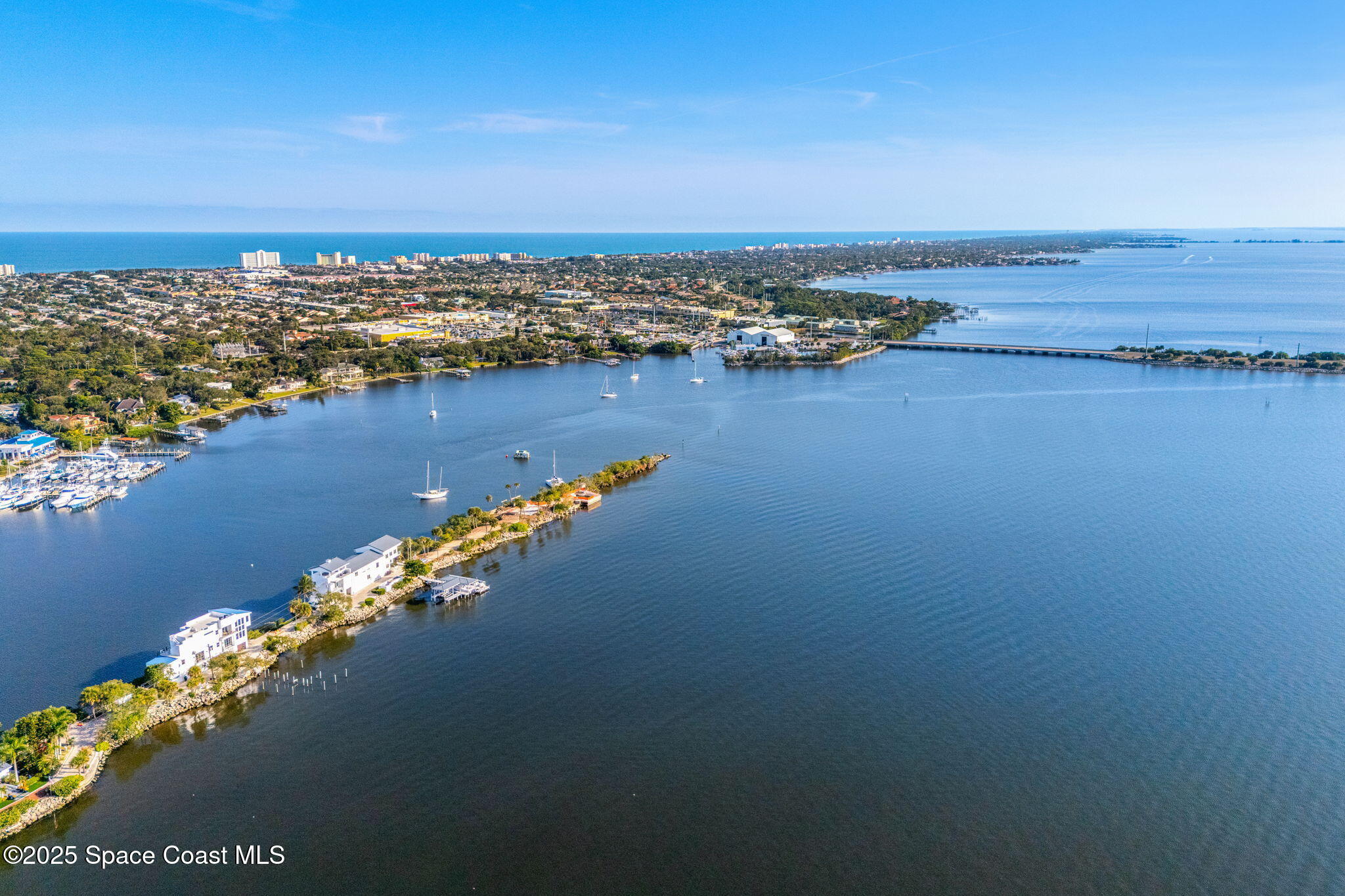 11680 Dragon Point Drive Merritt Island, FL 32952 - Photo 58 of 103 an aerial view of a ocean with residential houses with outdoor space