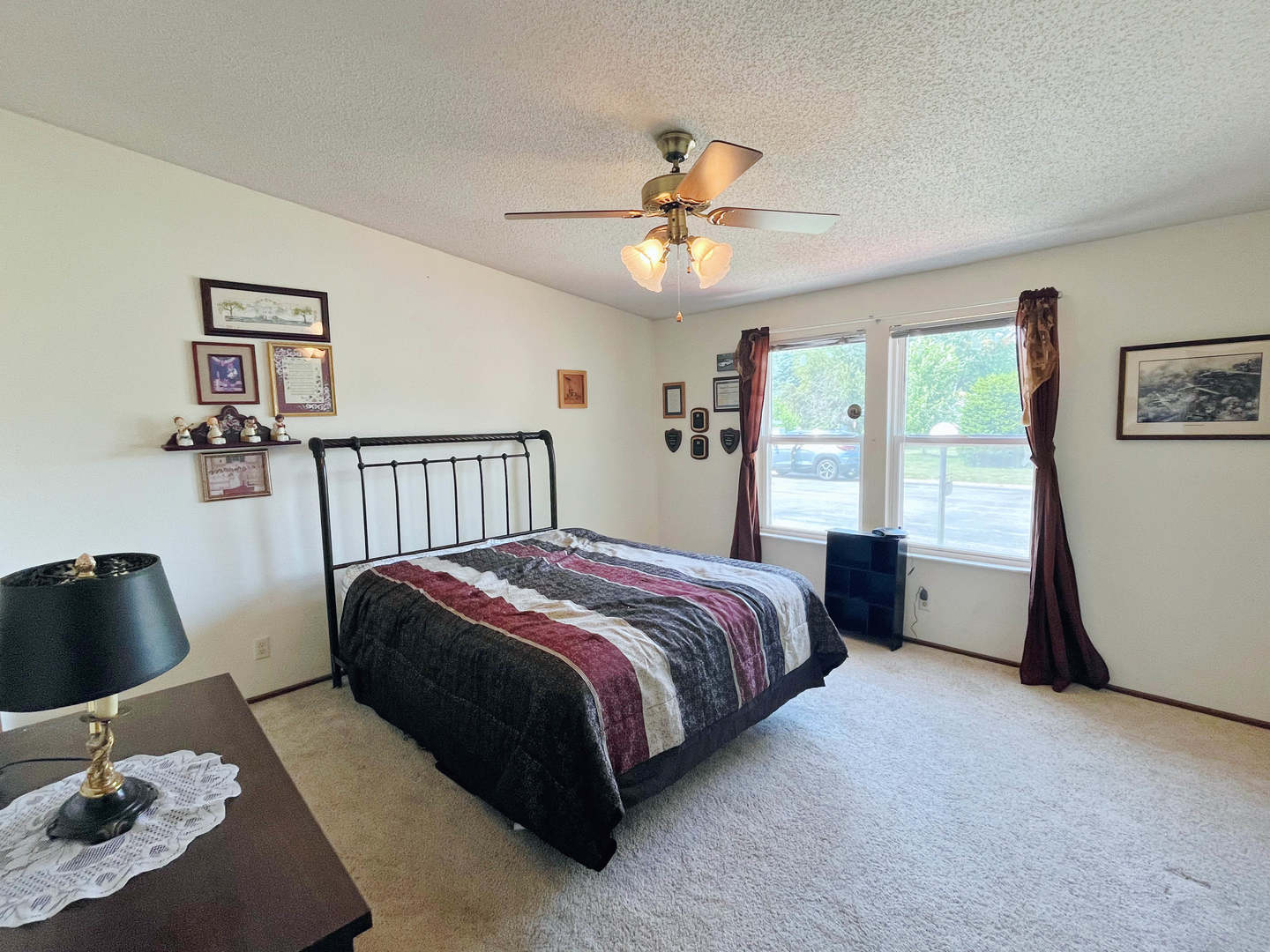 113 Cardinal Lane Sandwich, IL 60548 - Photo 11 of 14 a spacious bedroom with a bed a dresser and a large window