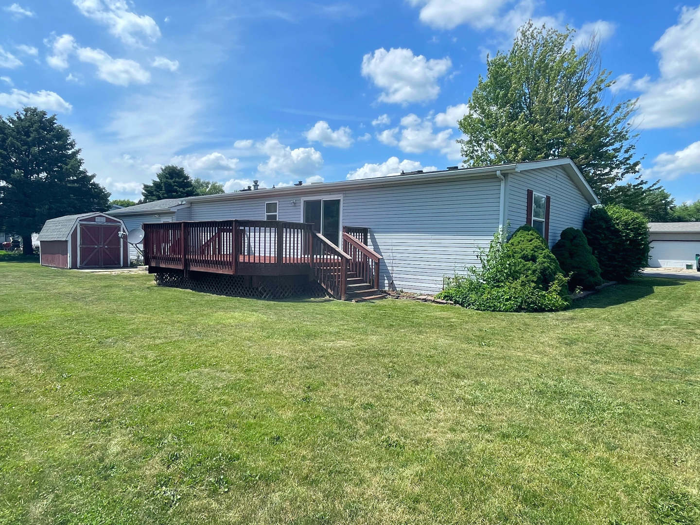 113 Cardinal Lane Sandwich, IL 60548 - Photo 14 of 14 a view of a house with a backyard and a garden