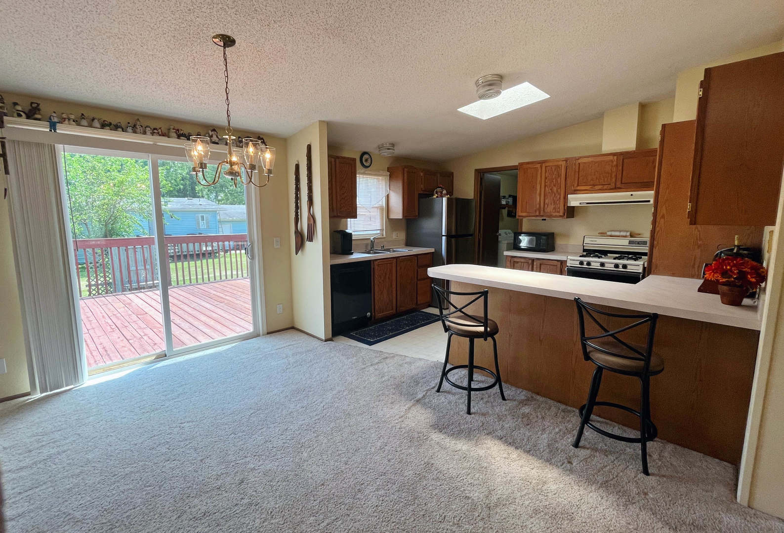 113 Cardinal Lane Sandwich, IL 60548 - Photo 4 of 14 a kitchen with a table chairs refrigerator and microwave
