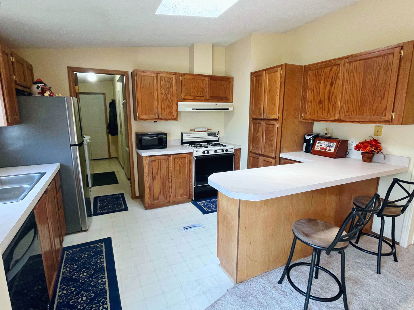 113 Cardinal Lane Sandwich, IL 60548 - Photo 5 of 14 a kitchen with a refrigerator a stove a sink and dishwasher