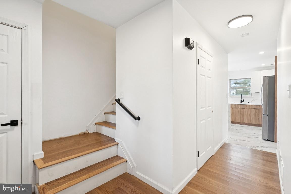 78 Kristopher Drive Hamilton, NJ 08620 - Photo 11 of 25 a view of a hallway with wooden floor and staircase
