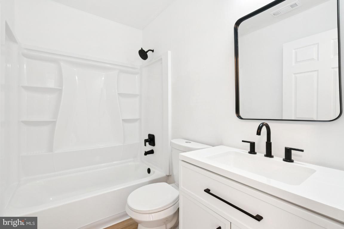 78 Kristopher Drive Hamilton, NJ 08620 - Photo 14 of 25 a bathroom with a toilet a sink a mirror a bathtub and shower