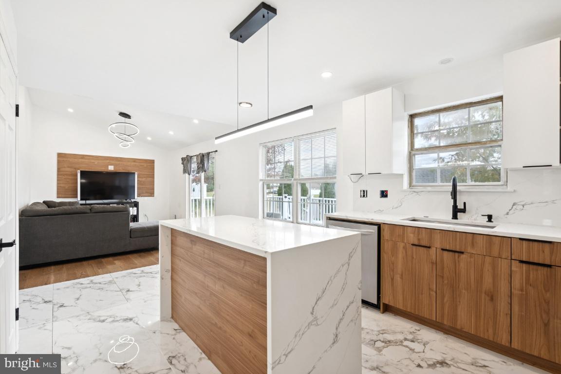 78 Kristopher Drive Hamilton, NJ 08620 - Photo 5 of 25 a large white kitchen with a sink and a stove top oven with wooden floor
