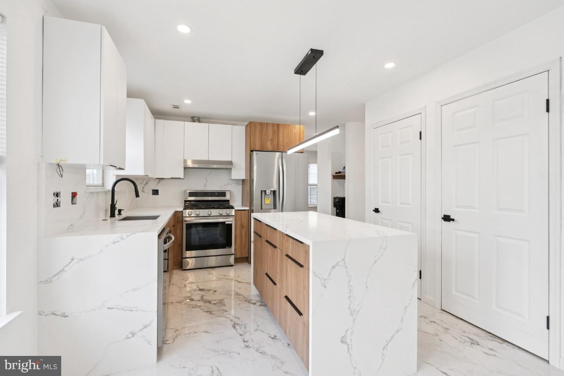 78 Kristopher Drive Hamilton, NJ 08620 - Photo 6 of 25 a kitchen with stainless steel appliances a stove sink and cabinets