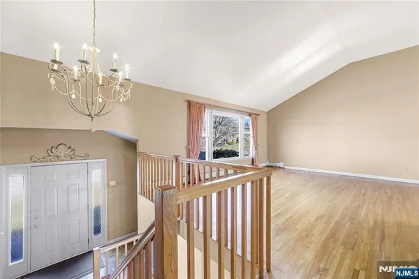 a view of an empty room and wooden floor