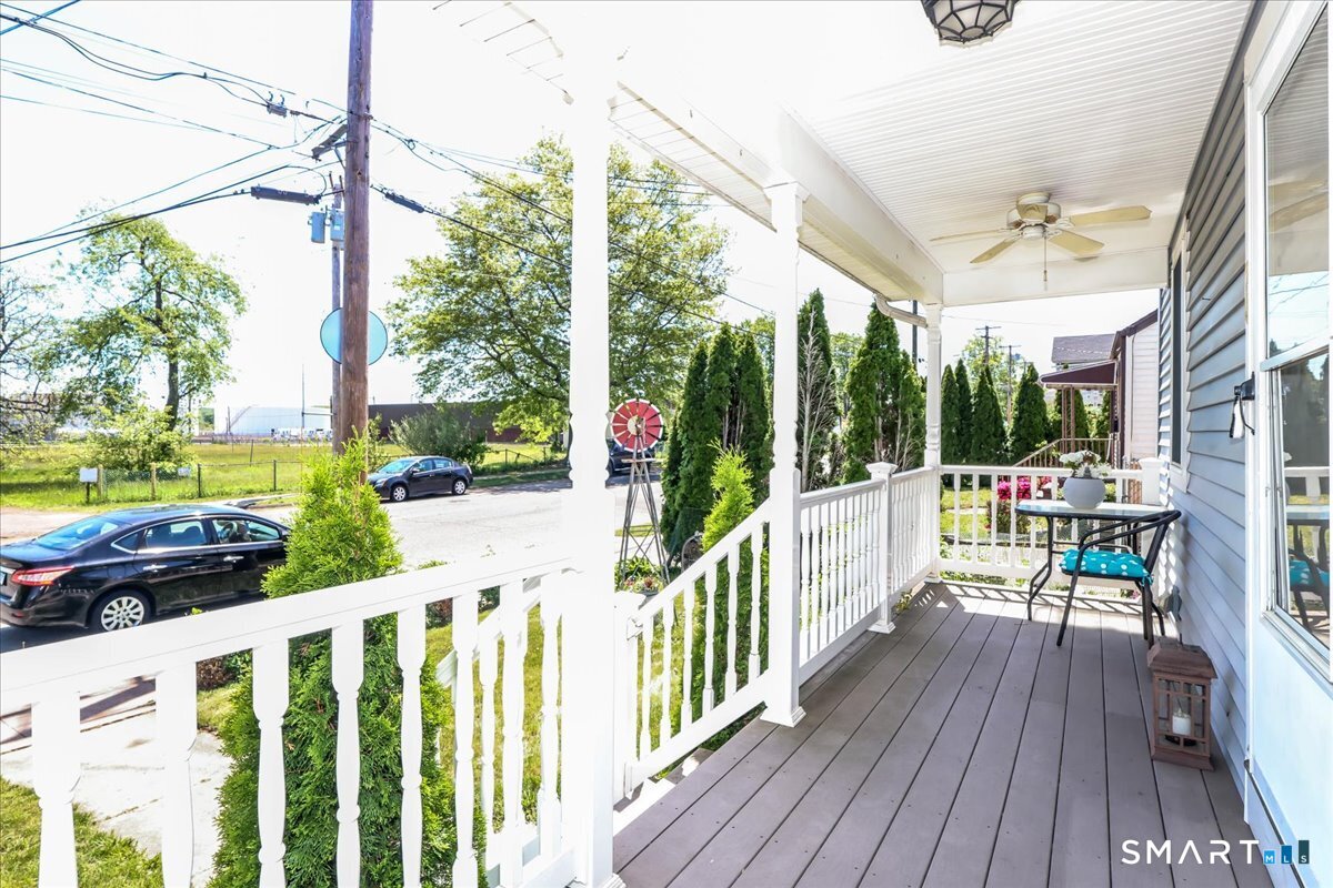 306 Welton Street Hamden, CT 06517 - Photo 2 of 38 a view of a porch with wooden floor and fence