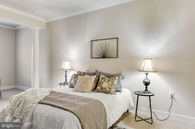 a bed room with a bed couches chair and a large window