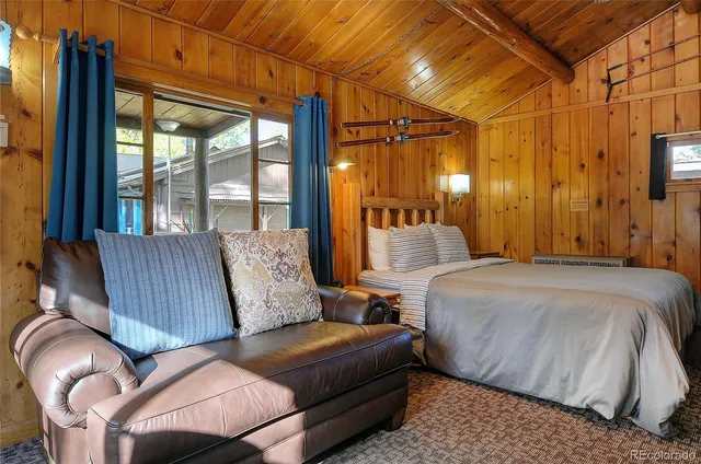 a bedroom with furniture and a large window