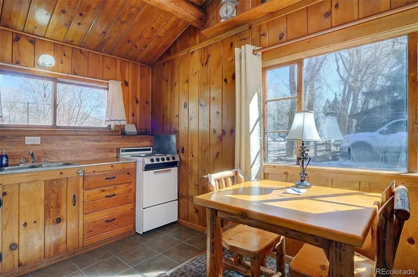 a kitchen with a table chairs and cabinets