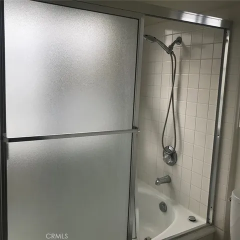 a bathroom with a glass shower door