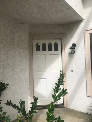 a front view of a house with potted plants