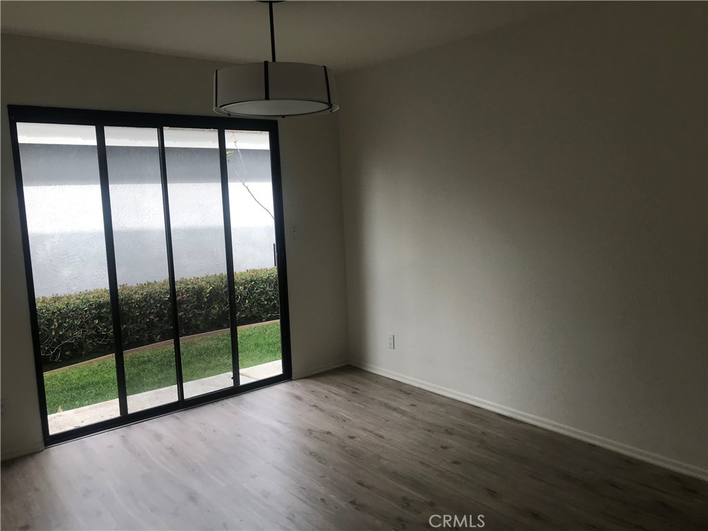 21 Silkberry Irvine, CA 92614 - Photo 6 of 18 a view of an empty room with wooden floor