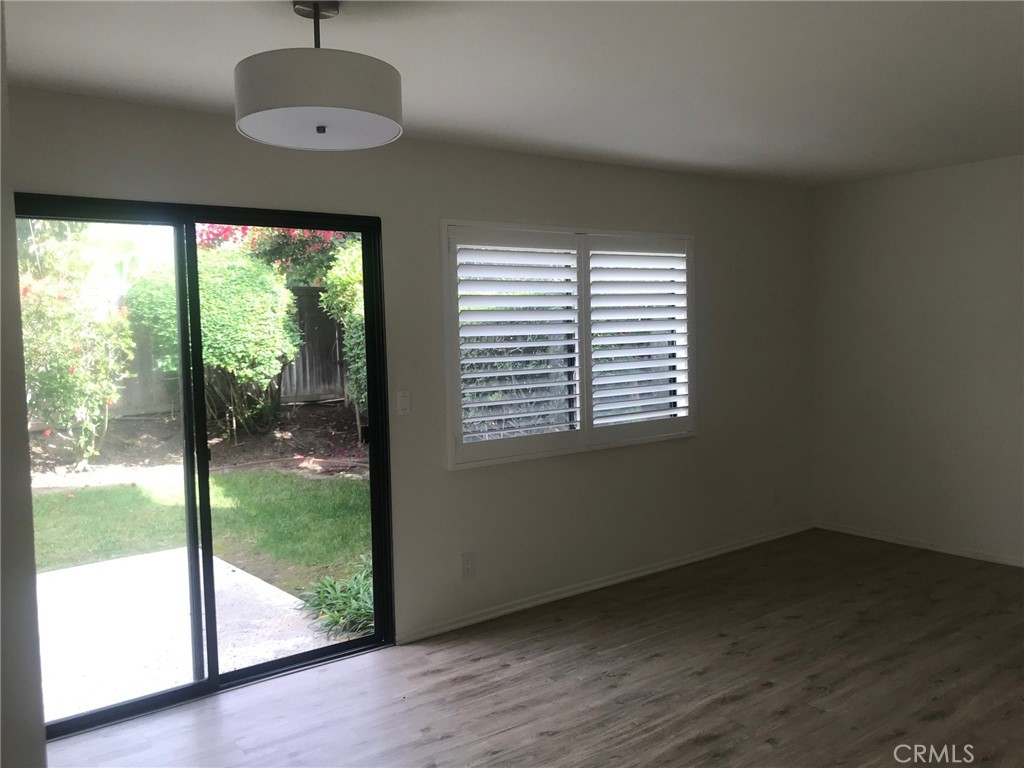 21 Silkberry Irvine, CA 92614 - Photo 7 of 18 an empty room with wooden floor and windows