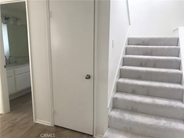 a view of staircase with white walls