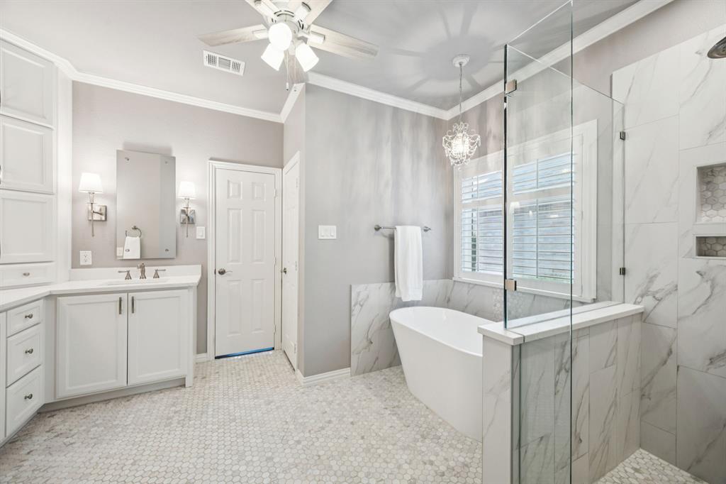 a bathroom with a tub sink shower and mirror