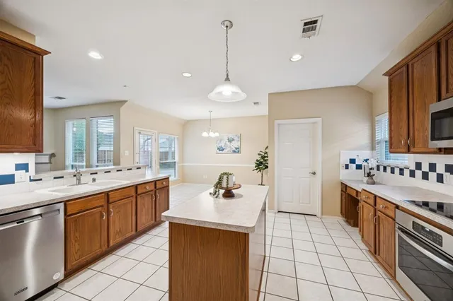 a kitchen with a sink stove and cabinets