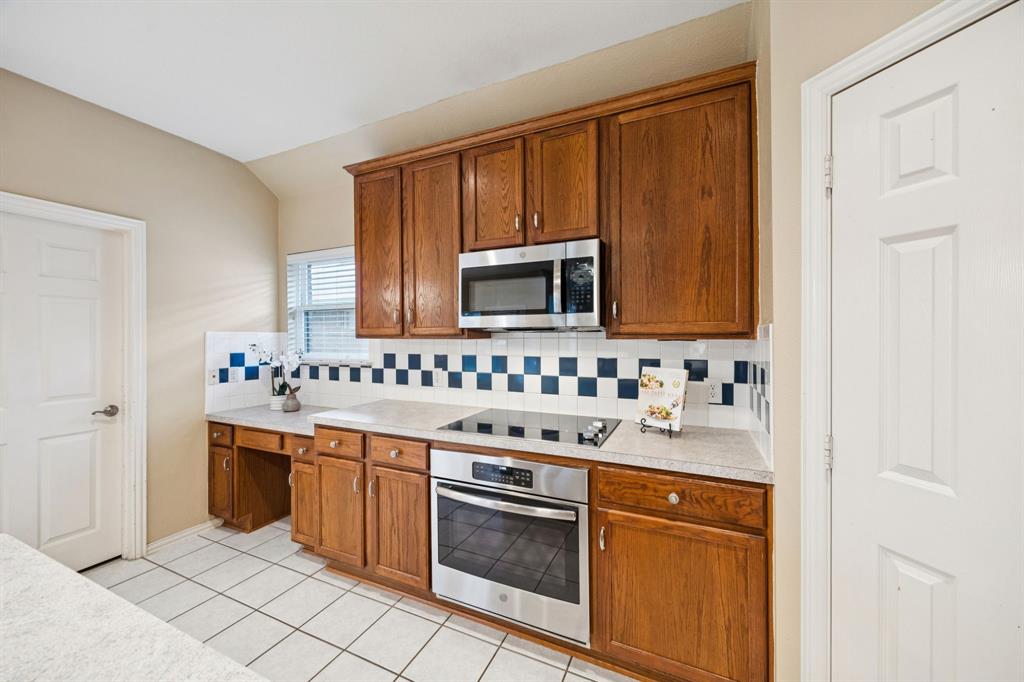 1516 High Country Lane Allen, TX 75002 - Photo 12 of 33 a kitchen with stainless steel appliances granite countertop a sink stove and microwave