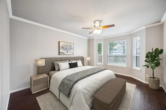 a bedroom with a bed a couch and potted plant