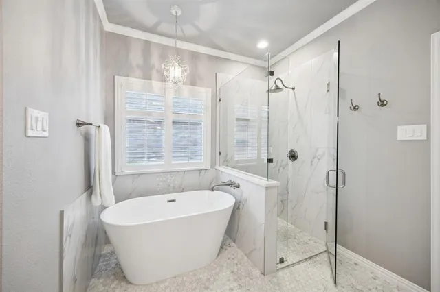 a bathroom with a bathtub and shower