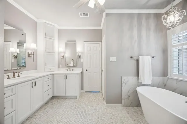 a spacious bathroom with a double vanity sink a large mirror and a bathtub