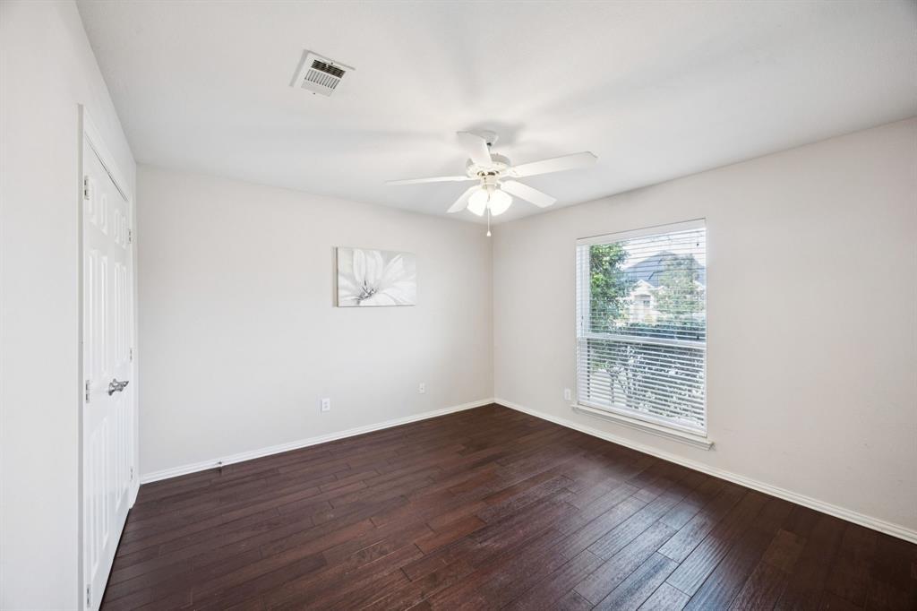 1516 High Country Lane Allen, TX 75002 - Photo 22 of 33 an empty room with wooden floor and windows