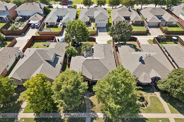 an aerial view of multiple houses with yard