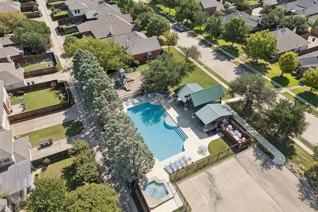 an aerial view of a house with a yard and lake view