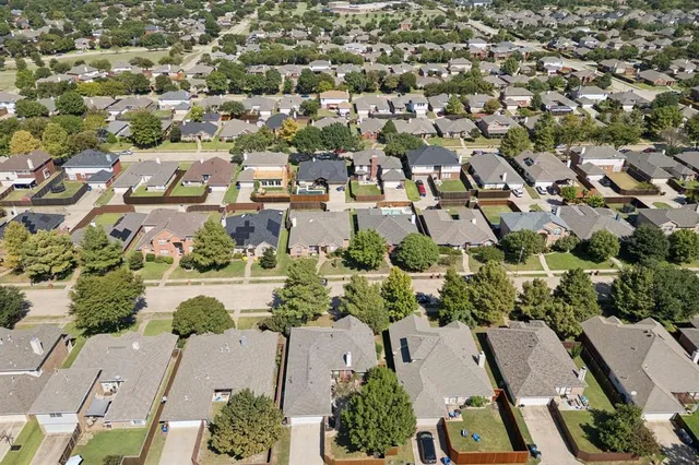 an aerial view of residential houses with outdoor space