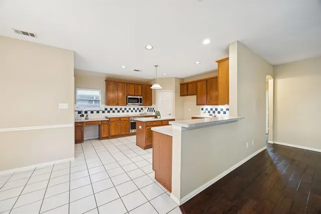 a kitchen with stainless steel appliances a sink and a refrigerator