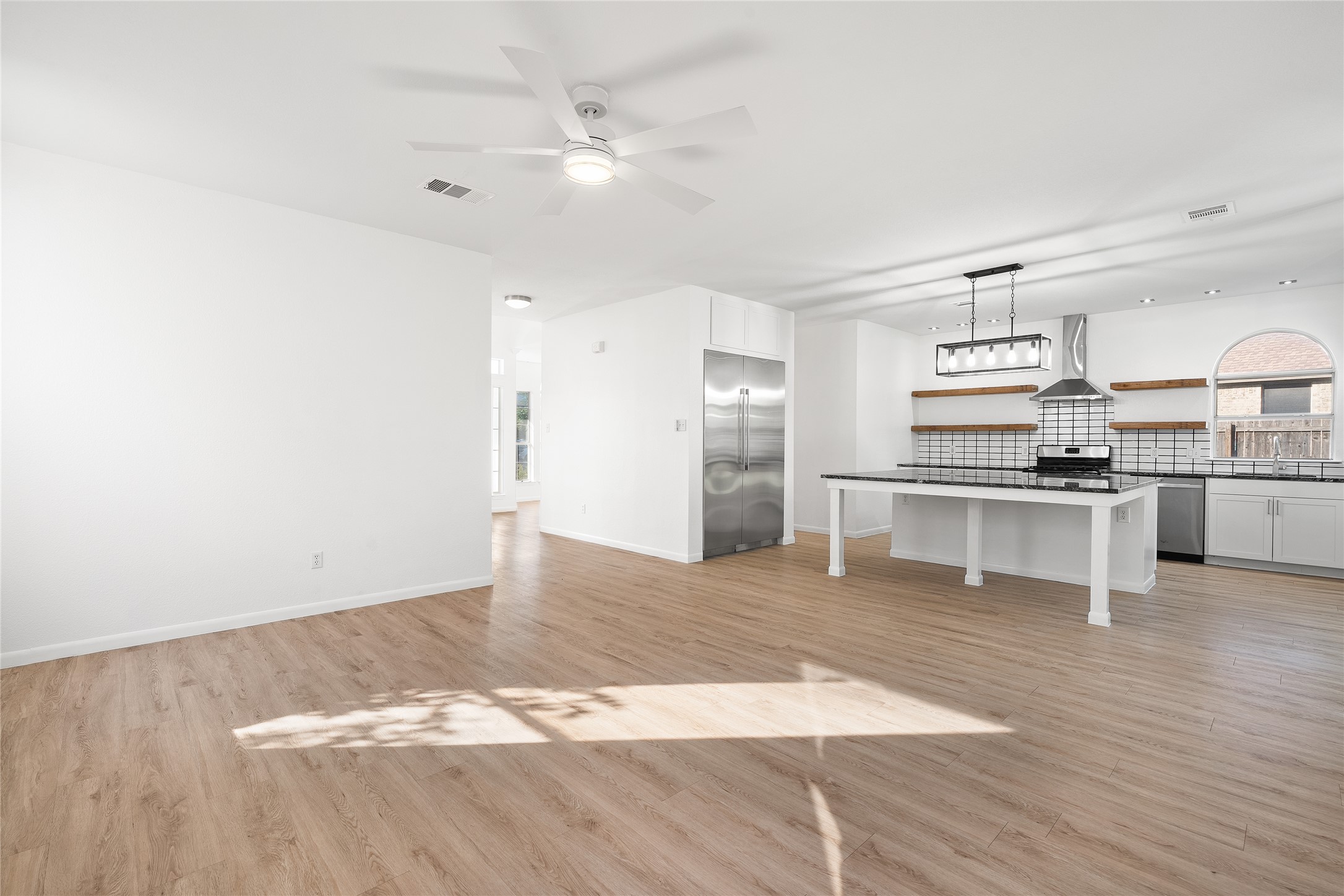 206 River Down Road Georgetown, TX 78628 - Photo 12 of 39 Open-concept living area with wood-finish flooring and a contemporary ceiling fan