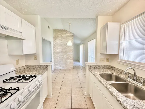 a kitchen that has a sink and a stove