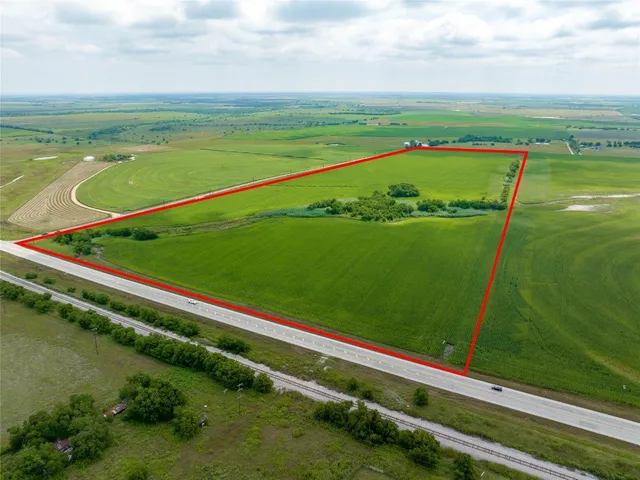 a view of a field with an ocean view